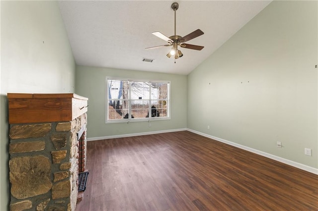 unfurnished living room with a fireplace, dark wood-type flooring, vaulted ceiling, and ceiling fan