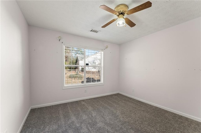 unfurnished room with dark carpet and ceiling fan