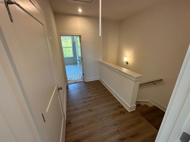 1392 Cozy Cir Unit 349, Atlanta, GA 30315 - hallway featuring wood finished floors, baseboards, and an upstairs landing