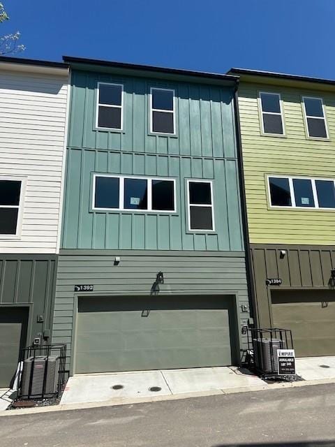 1392 Cozy Cir Unit 349, Atlanta, GA 30315 - view of property with board and batten siding, a garage, and central AC