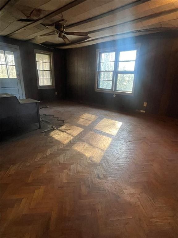 empty room featuring ceiling fan and dark parquet floors