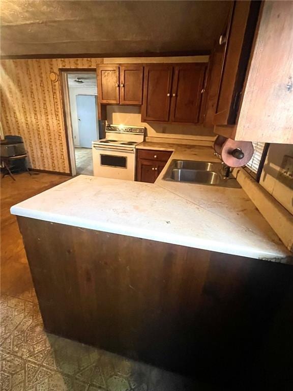 kitchen featuring white range with electric stovetop and sink