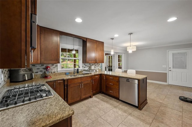 3912 Edenton Ct NE, Brookhaven, GA 30319 - kitchen with appliances with stainless steel finishes, a sink, backsplash, a peninsula, and light stone countertops