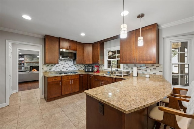 3912 Edenton Ct NE, Brookhaven, GA 30319 - kitchen with stainless steel appliances, a peninsula, tasteful backsplash, ornamental molding, and hanging light fixtures