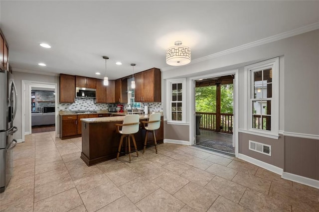 3912 Edenton Ct NE, Brookhaven, GA 30319 - kitchen with appliances with stainless steel finishes, crown molding, a peninsula, baseboards, and decorative backsplash