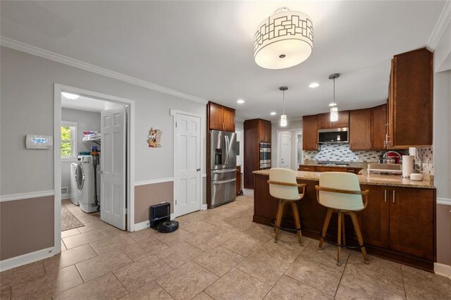 3912 Edenton Ct NE, Brookhaven, GA 30319 - kitchen with appliances with stainless steel finishes, baseboards, tasteful backsplash, independent washer and dryer, and a peninsula