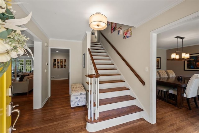 3912 Edenton Ct NE, Brookhaven, GA 30319 - staircase featuring wood finished floors, ornamental molding, a chandelier, and baseboards