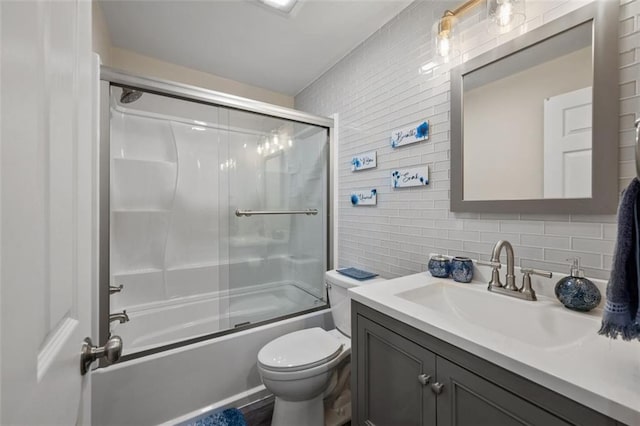 3912 Edenton Ct NE, Brookhaven, GA 30319 - full bath with backsplash, bath / shower combo with glass door, vanity, toilet, and tile walls