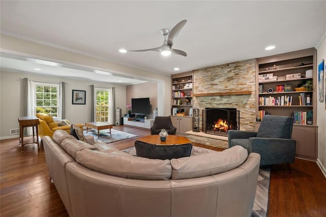 3912 Edenton Ct NE, Brookhaven, GA 30319 - living room with dark wood finished floors, a fireplace, built in features, a ceiling fan, and ornamental molding