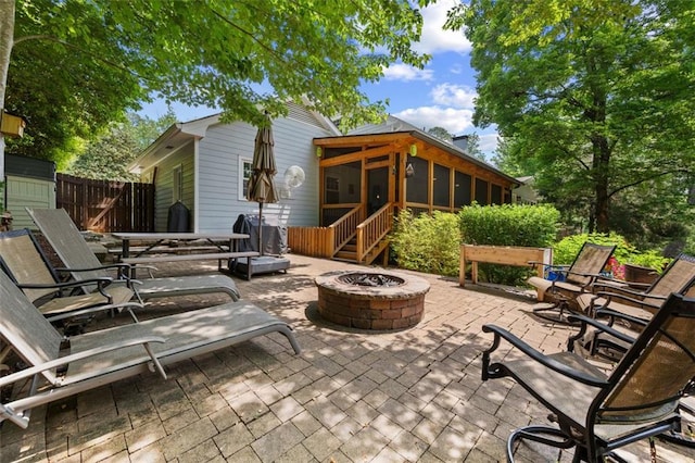 3912 Edenton Ct NE, Brookhaven, GA 30319 - view of patio featuring a fire pit, a sunroom, and fence