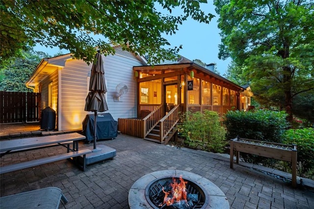 3912 Edenton Ct NE, Brookhaven, GA 30319 - back of property featuring a fire pit, a patio area, fence, and a sunroom