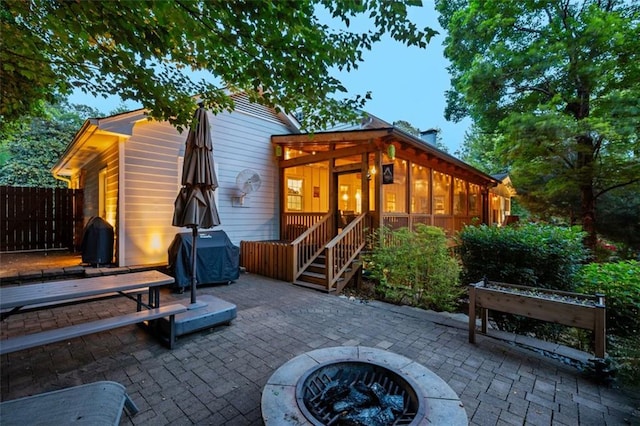 3912 Edenton Ct NE, Brookhaven, GA 30319 - back of property featuring a fire pit, a patio area, a sunroom, and fence
