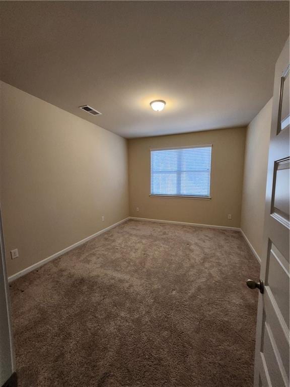 unfurnished room featuring carpet