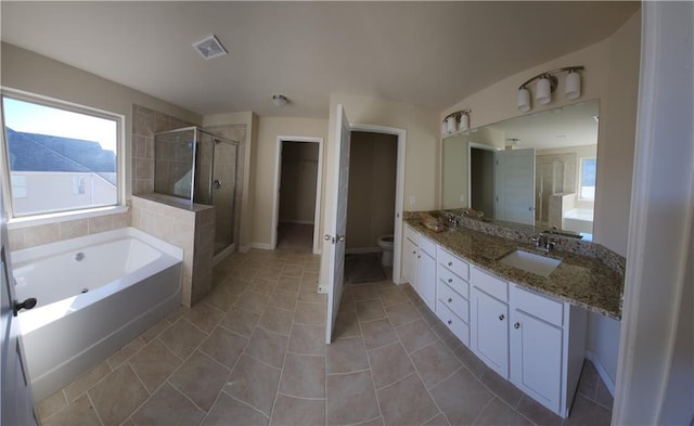 full bathroom featuring tile patterned flooring, plus walk in shower, vanity, and toilet