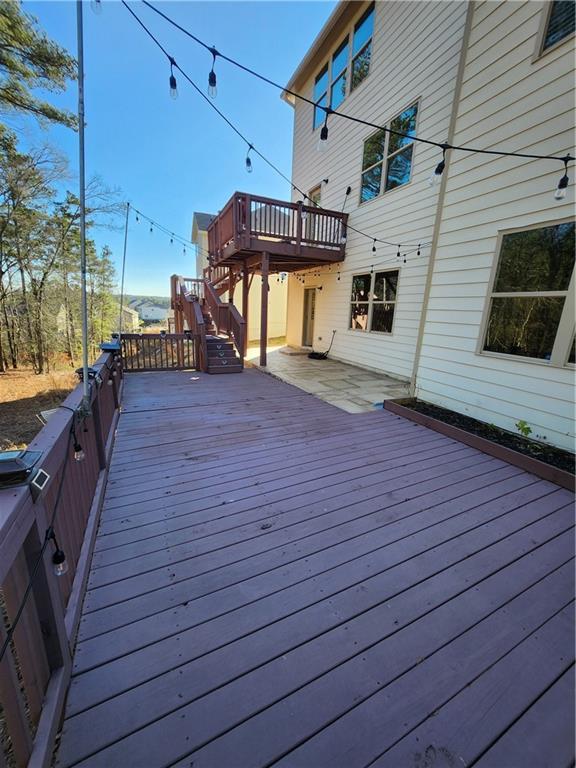 wooden terrace with a patio area