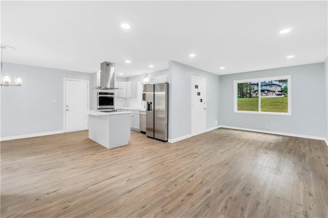 3355 Wesley Chapel Rd, Decatur, GA 30034 - kitchen with stainless steel appliances, island range hood, open floor plan, a center island, and recessed lighting