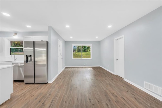 3355 Wesley Chapel Rd, Decatur, GA 30034 - kitchen with stainless steel appliances, light wood-style flooring, white cabinetry, light countertops, and recessed lighting