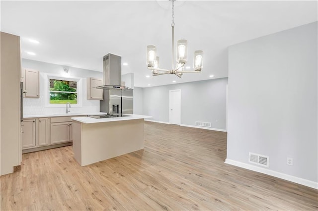 3355 Wesley Chapel Rd, Decatur, GA 30034 - kitchen featuring island exhaust hood, a kitchen island, light wood finished floors, a chandelier, and baseboards