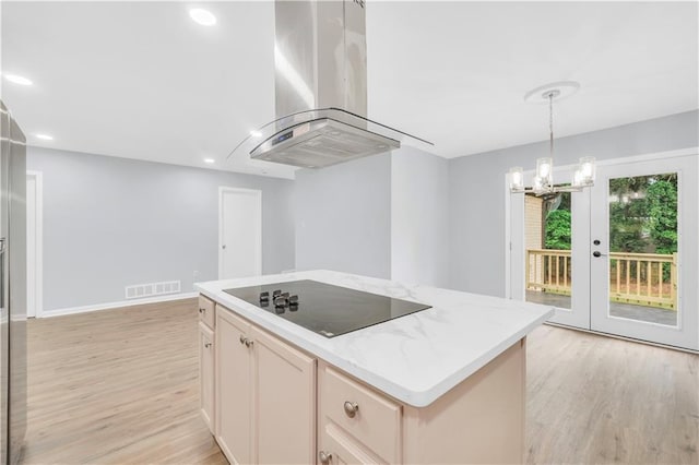 3355 Wesley Chapel Rd, Decatur, GA 30034 - kitchen with range hood, black electric cooktop, light wood-style floors, a kitchen island, and a chandelier