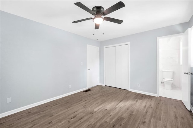3355 Wesley Chapel Rd, Decatur, GA 30034 - unfurnished bedroom with baseboards, wood finished floors, a closet, ensuite bath, and a ceiling fan