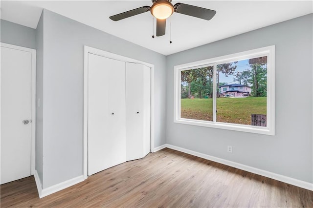3355 Wesley Chapel Rd, Decatur, GA 30034 - unfurnished bedroom with wood finished floors, a closet, baseboards, and ceiling fan