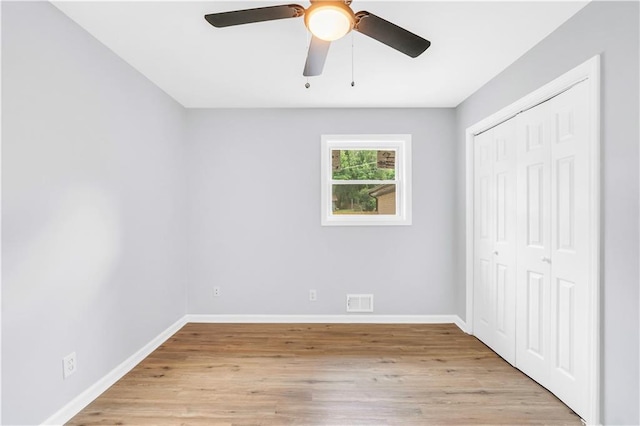 3355 Wesley Chapel Rd, Decatur, GA 30034 - unfurnished bedroom with baseboards, a closet, light wood-style floors, and a ceiling fan