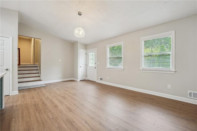 interior space featuring light hardwood / wood-style flooring and lofted ceiling