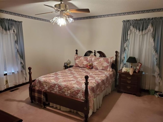 bedroom with ceiling fan and light colored carpet