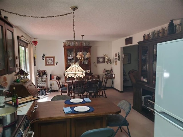 dining space with a chandelier, light carpet, and a textured ceiling