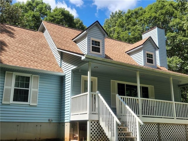 back of house featuring a porch