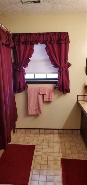 bathroom with vanity and a textured ceiling