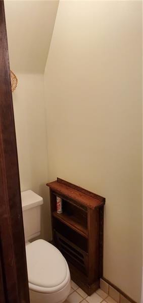 bathroom featuring toilet and tile patterned flooring