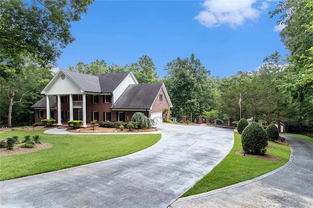 402 Clyde Ct, Mcdonough, GA 30252 - greek revival inspired property featuring concrete driveway, a front lawn, a garage, and brick siding