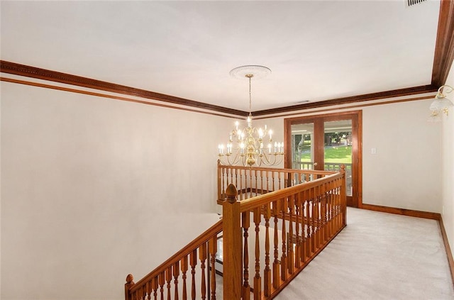402 Clyde Ct, Mcdonough, GA 30252 - hall with an upstairs landing, ornamental molding, a chandelier, and light carpet