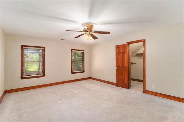 402 Clyde Ct, Mcdonough, GA 30252 - spare room with healthy amount of natural light, light colored carpet, and a ceiling fan