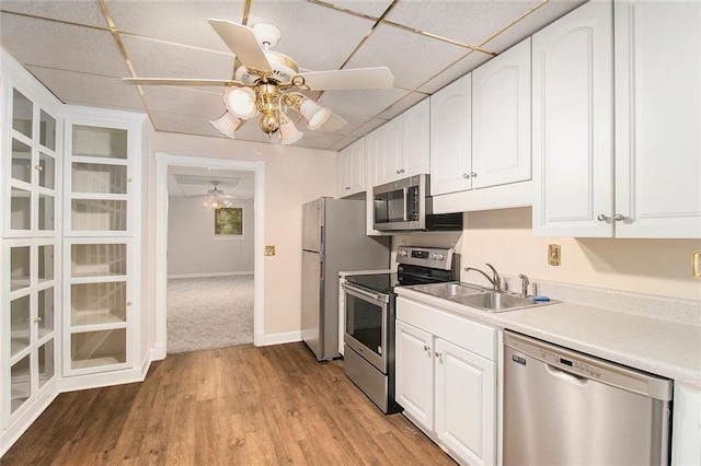 402 Clyde Ct, Mcdonough, GA 30252 - kitchen featuring stainless steel appliances, ceiling fan, white cabinetry, light wood-style floors, and light countertops