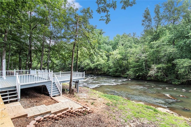 402 Clyde Ct, Mcdonough, GA 30252 - view of yard with stairway, a deck, and a forest view