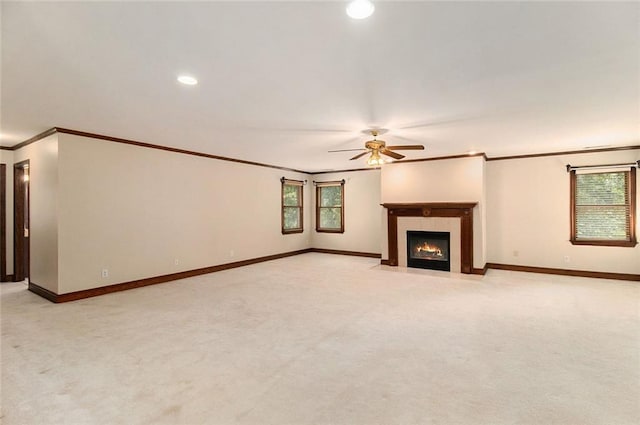 402 Clyde Ct, Mcdonough, GA 30252 - unfurnished living room featuring crown molding, a ceiling fan, light carpet, plenty of natural light, and a fireplace with flush hearth