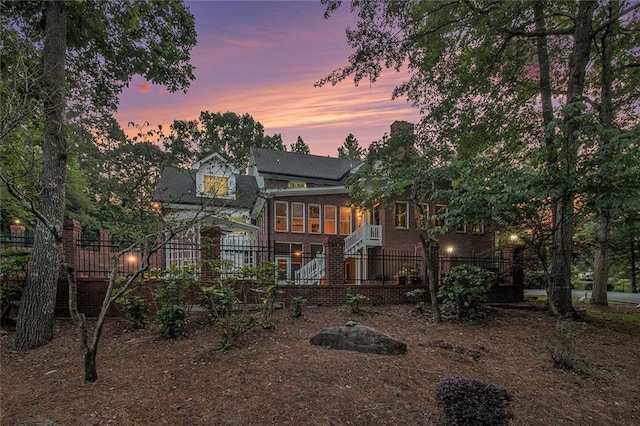 402 Clyde Ct, Mcdonough, GA 30252 - rear view of house featuring a sunroom, brick siding, and stairway