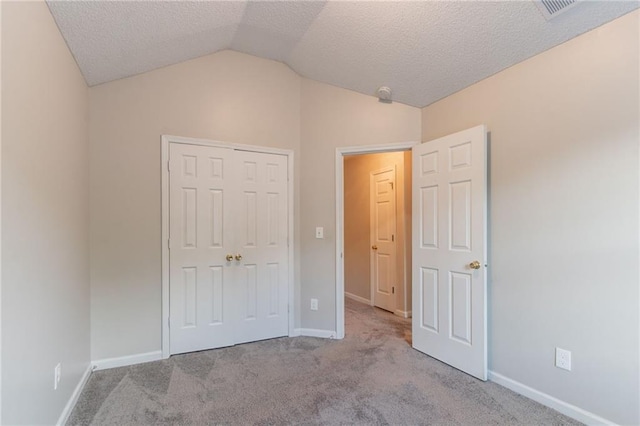 6304 Kendra Ln, Lithonia, GA 30058 - unfurnished bedroom with lofted ceiling, carpet floors, a textured ceiling, and a closet