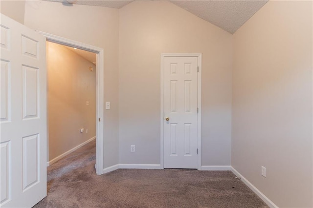 6304 Kendra Ln, Lithonia, GA 30058 - unfurnished bedroom with carpet flooring, lofted ceiling, and a textured ceiling