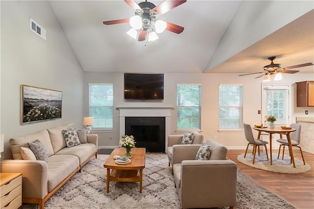 6304 Kendra Ln, Lithonia, GA 30058 - living area featuring lofted ceiling, ceiling fan, light wood finished floors, and a fireplace