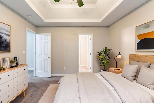 6304 Kendra Ln, Lithonia, GA 30058 - bedroom with dark carpet, a raised ceiling, connected bathroom, and a ceiling fan