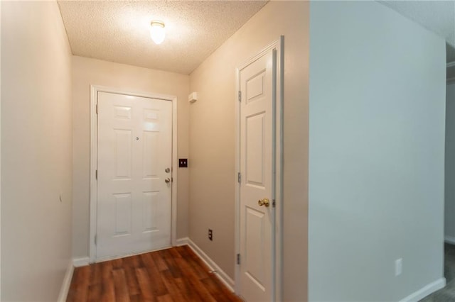 6304 Kendra Ln, Lithonia, GA 30058 - doorway featuring dark wood finished floors and a textured ceiling