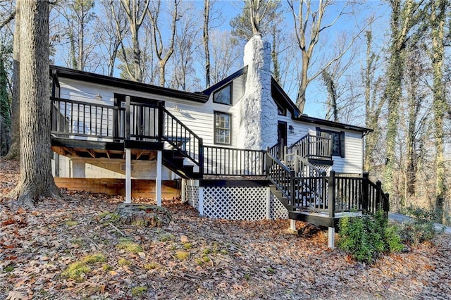 rear view of house featuring a wooden deck