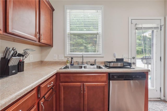 kitchen with a sink, light countertops, and dishwasher