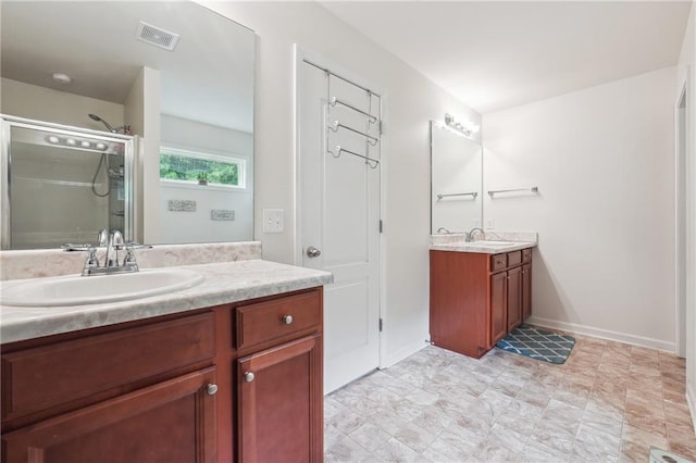 full bathroom with a stall shower, two vanities, a sink, and visible vents