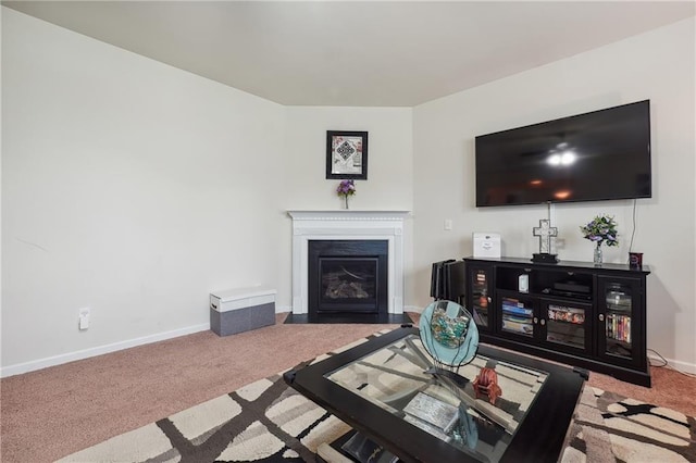 carpeted living room with a fireplace with flush hearth and baseboards