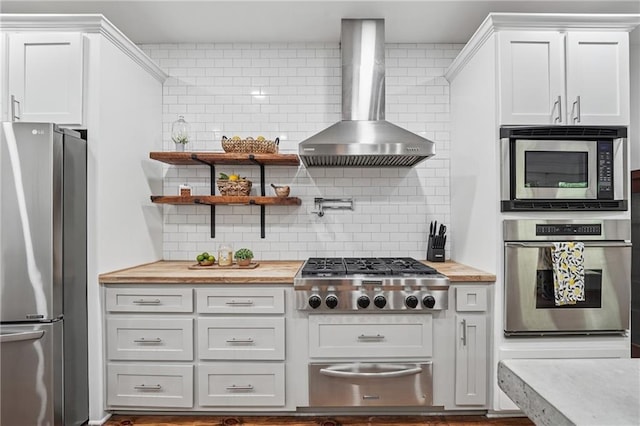 2945 Ashbyrn Ct, Buford, GA 30519 - kitchen featuring appliances with stainless steel finishes, wall chimney range hood, and tasteful backsplash