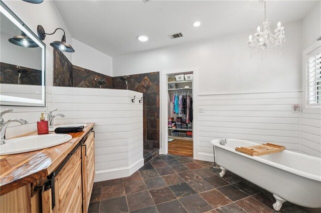 2945 Ashbyrn Ct, Buford, GA 30519 - full bathroom with a tile shower, stone finish flooring, double vanity, a soaking tub, and a spacious closet